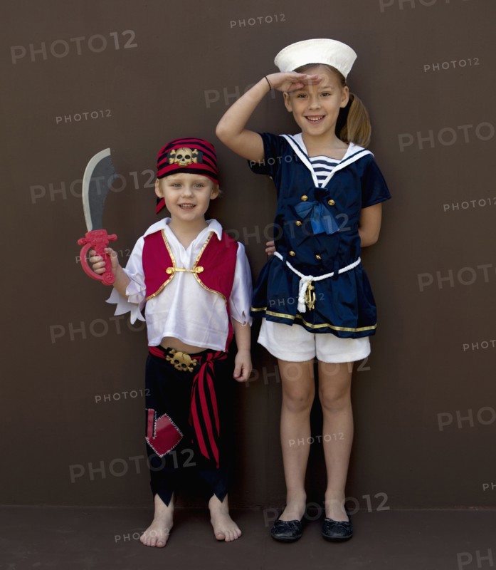 Caucasian children playing dress up