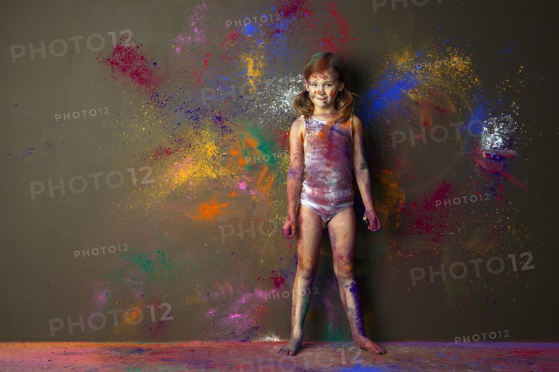 Caucasian girl playing with paint