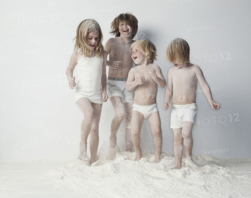 Caucasian children playing in flour