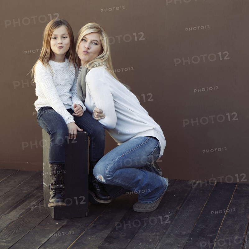 Caucasian mother and daughter smiling together