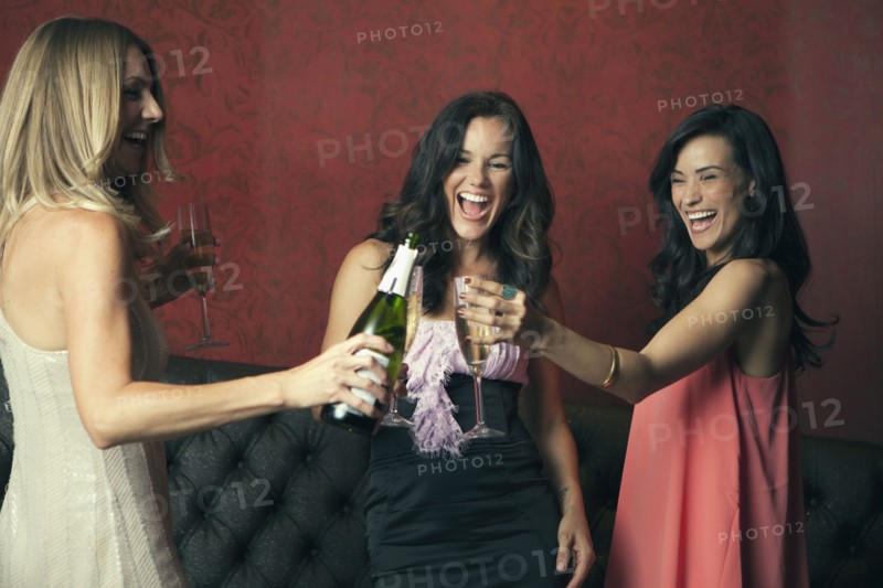 Women toasting with champagne in nightclub