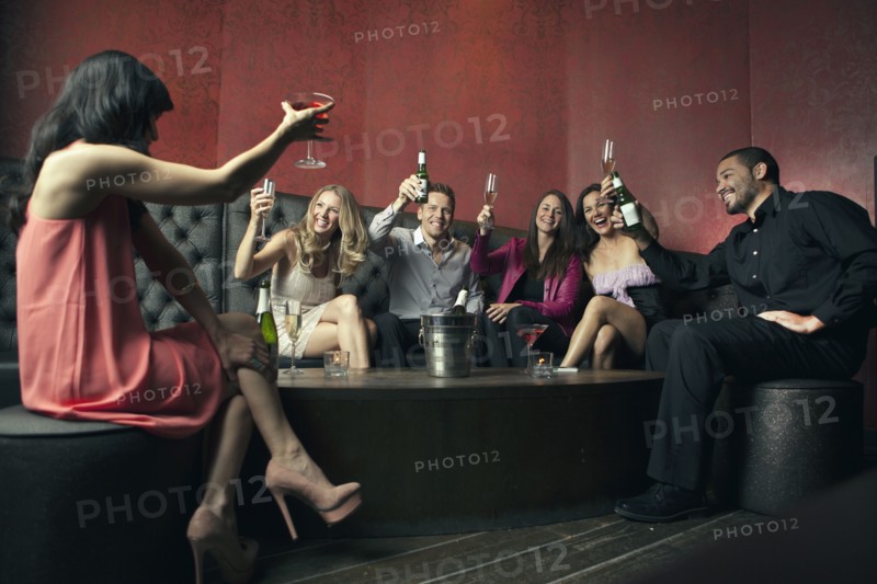 Friends toasting each other in nightclub