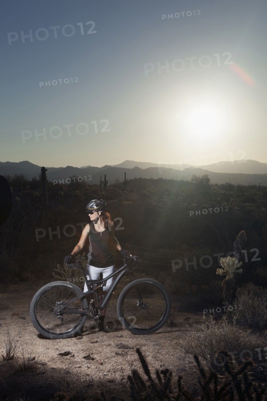 Mountain biker standing in desert