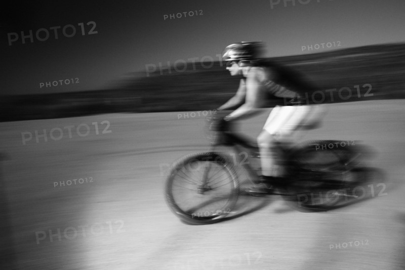 Woman riding mountain bike in desert