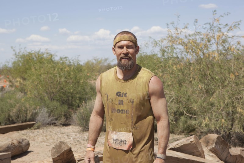 Dirty Caucasian racer in remote landscape
