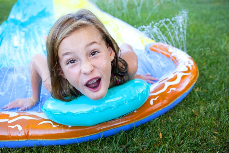 Caucasian girl smiling on water slide