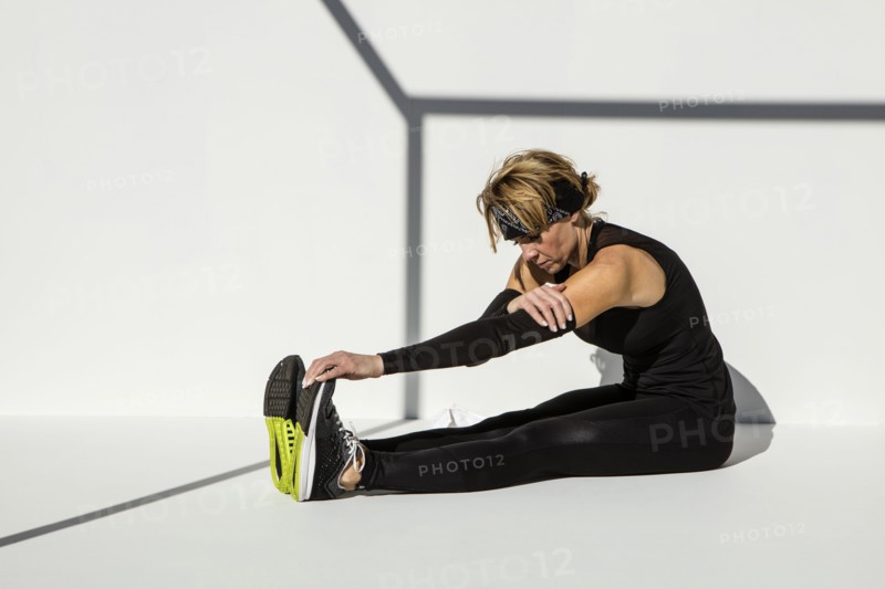 Caucasian athlete stretching leg