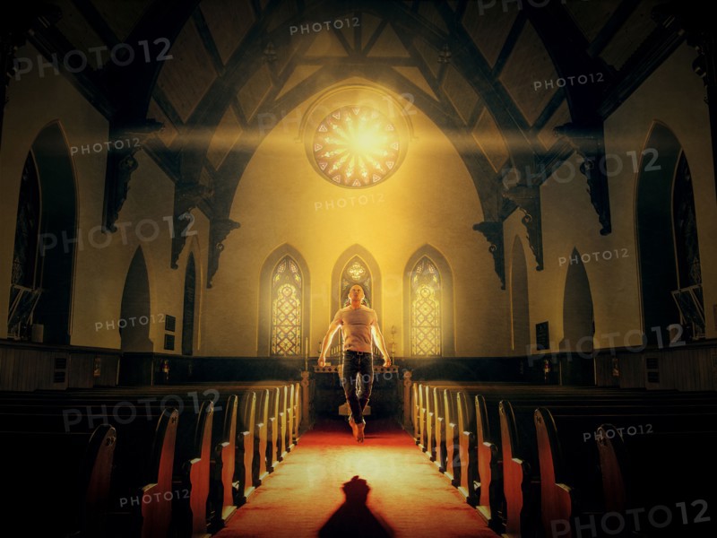 Caucasian man floating in church