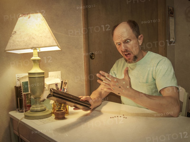 Caucasian man with holes punched in hand