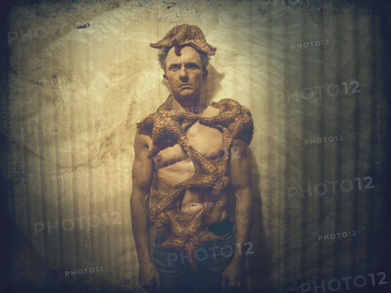 Caucasian man covered in starfish