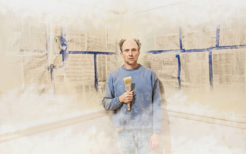 Caucasian man painting himself into corner