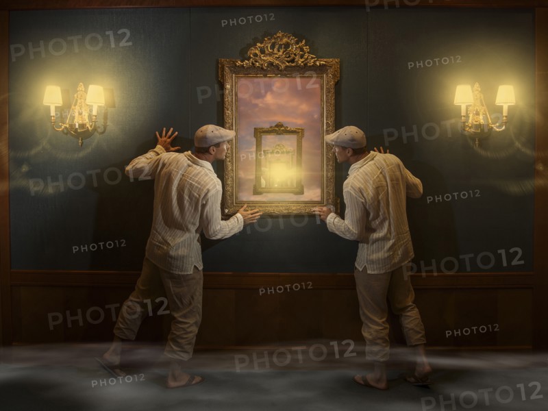 Caucasian twins peering into mirror