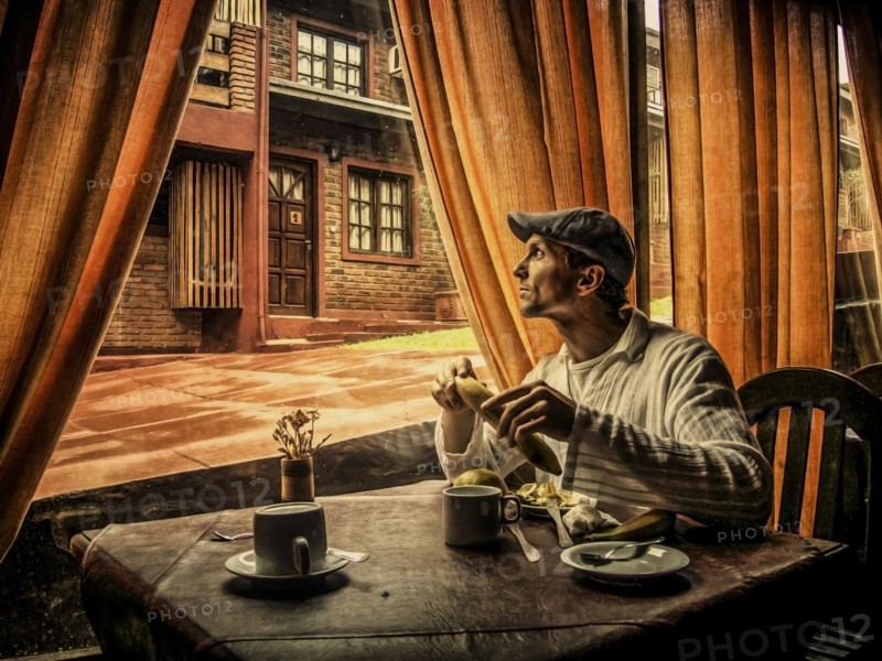 Caucasian man eating in cafe