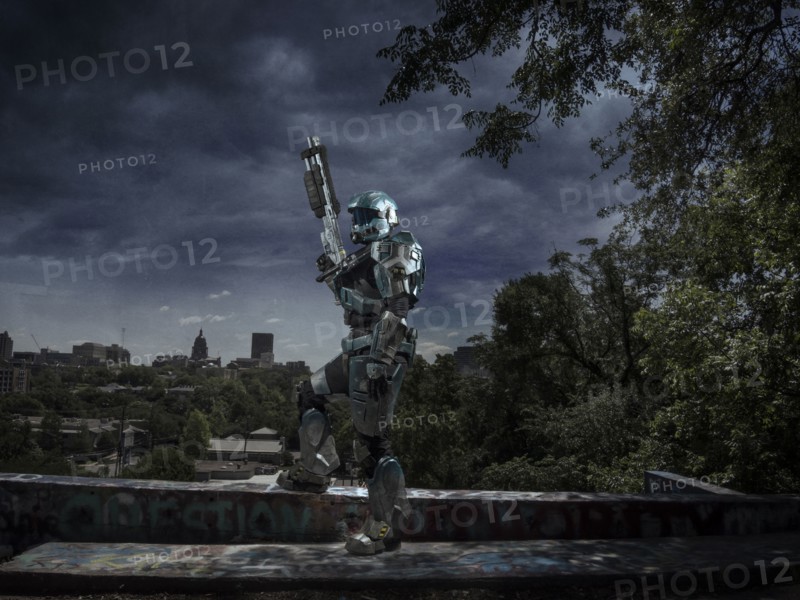 Robot patrolling city holding rifle