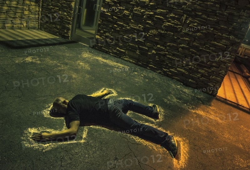 Chalk outline of body of Caucasian victim on pavement