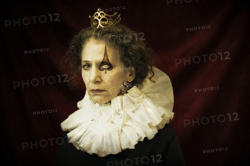 Caucasian queen with spade drawn over eye