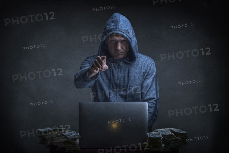 Caucasian hacker stealing money from laptop
