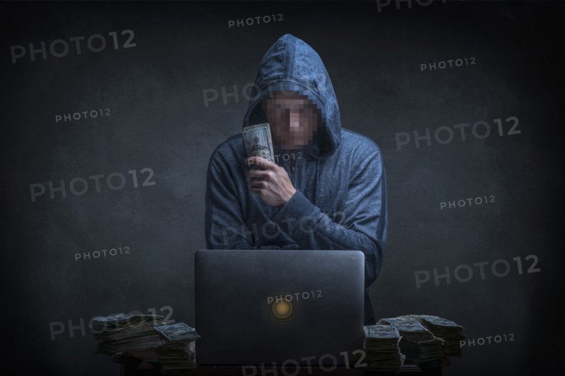 Caucasian hacker stealing money from laptop