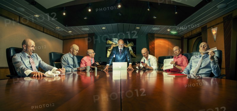Multiple exposure of Caucasian businessmen in conference room