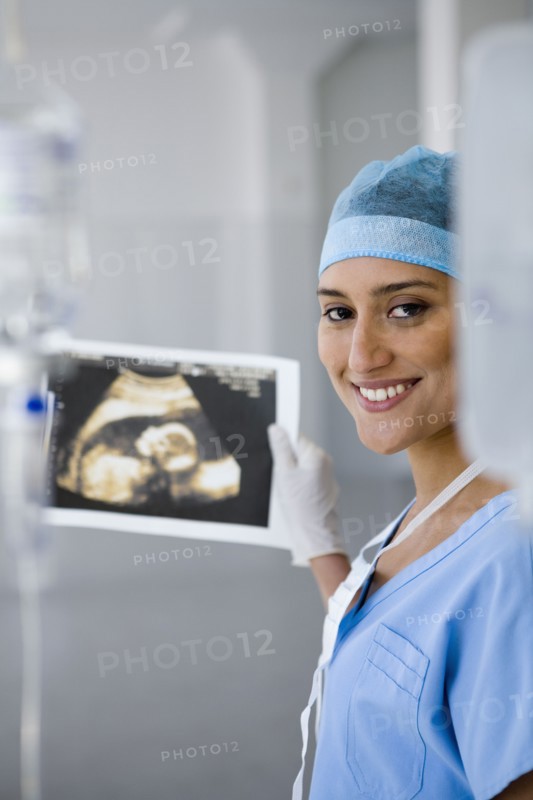 Female doctor holding sonogram