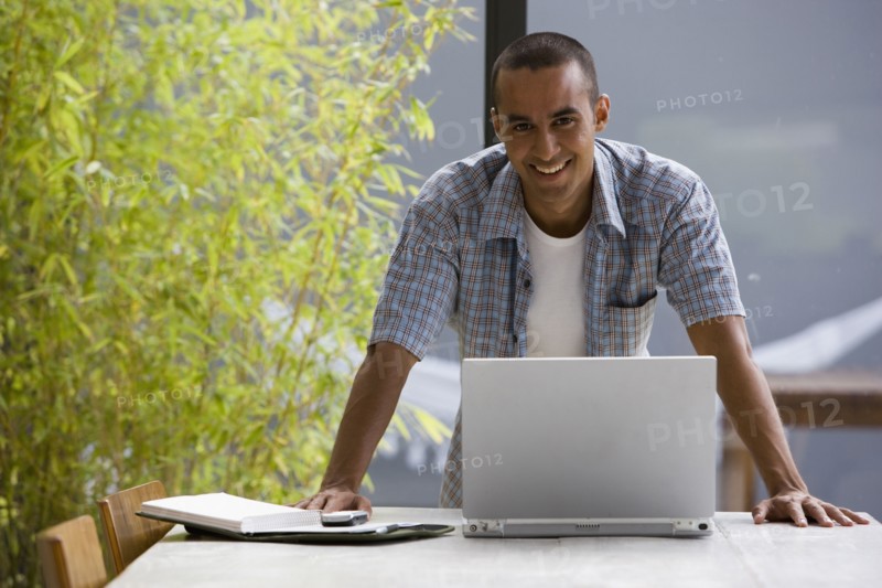 Portrait of young man with laptop