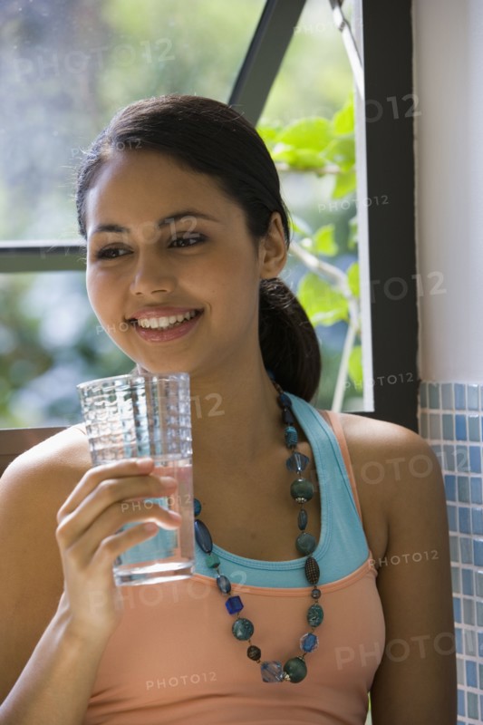 Young woman drinking glass of water