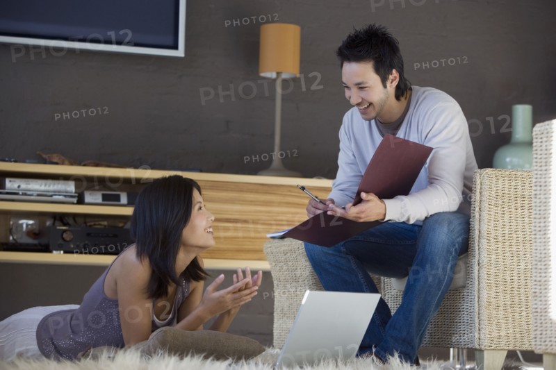 Asian couple working at home