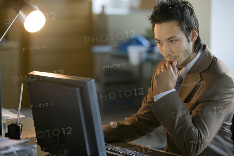 Asian businessman looking at computer