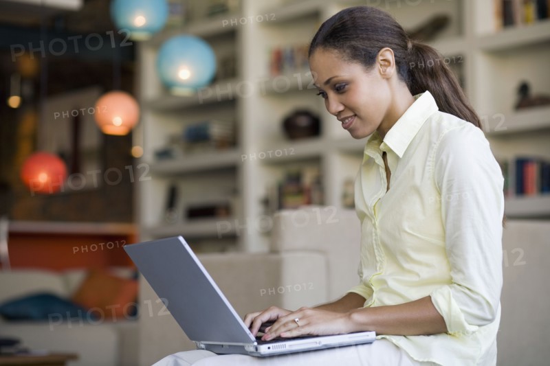 African American woman typing on laptop