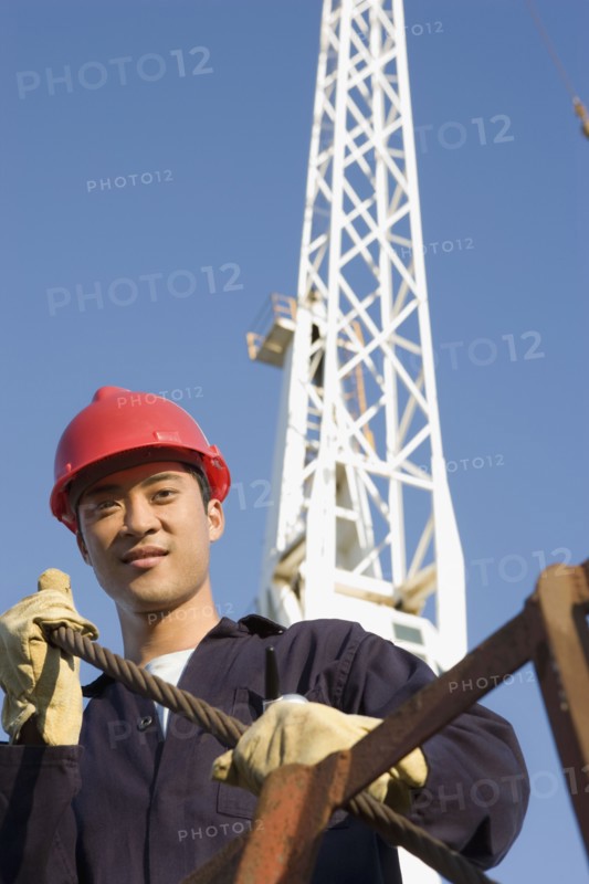 Asian male construction worker wearing hardhat