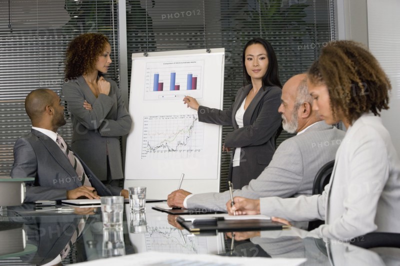 Multi-ethnic businesswomen giving presentation