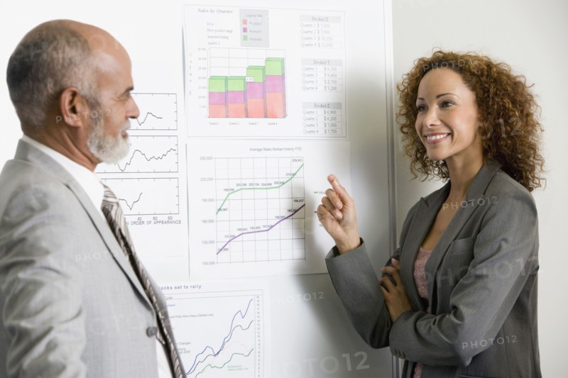 African businesspeople next to graphs