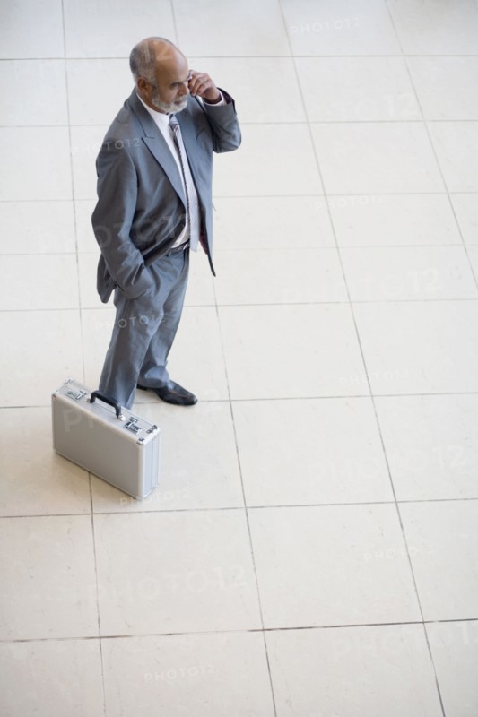 Senior African businessman talking on cell phone