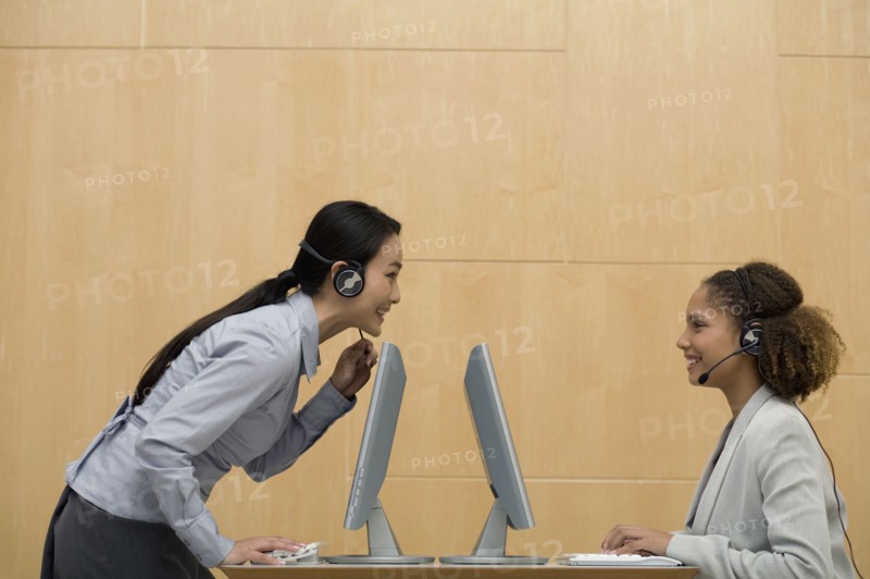 Multi-ethnic businesswomen wearing headsets