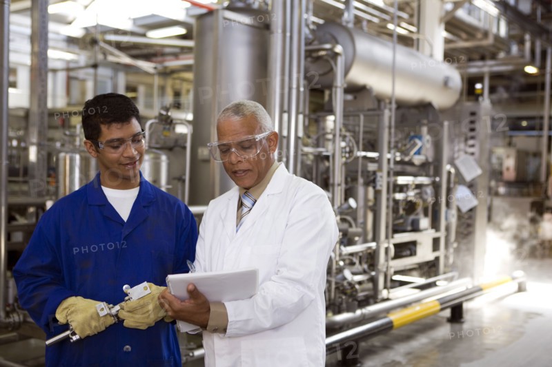 Scientist talking to factory worker