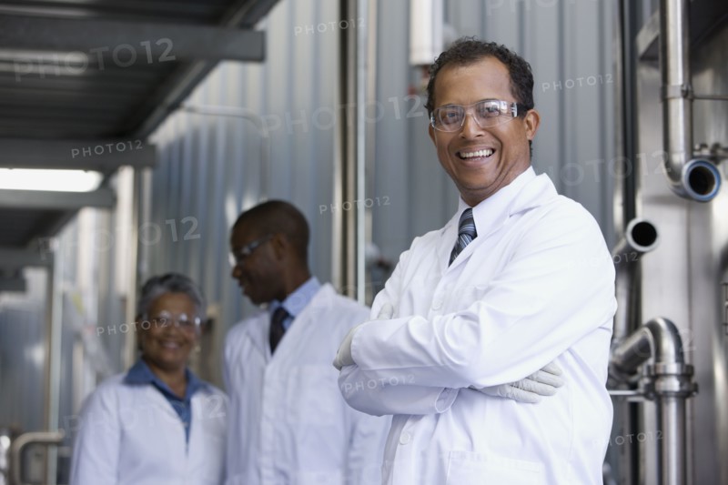 African scientists standing in factory