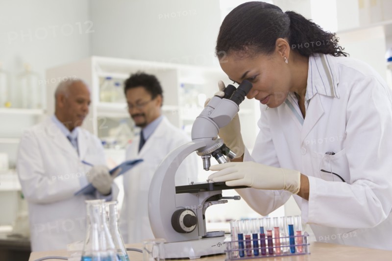African scientist performing analysis in laboratory with microscope