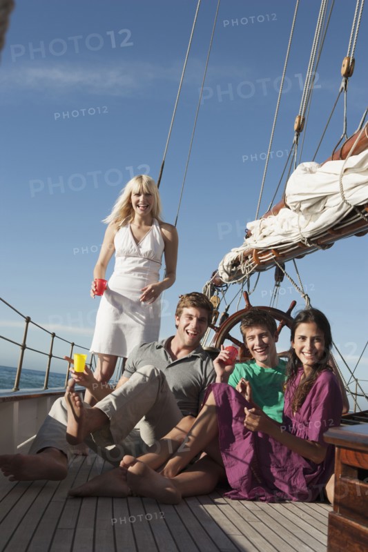 Caucasian friends relaxing on sailboat