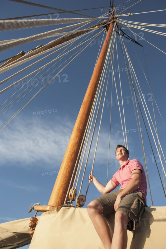 Caucasian man relaxing on sailboat