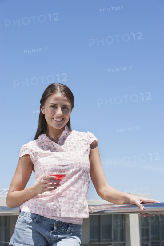 Caucasian woman drinking cocktail outdoors