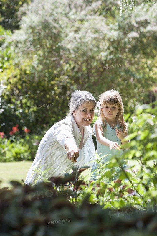 Grandmother and granddaughter in garden