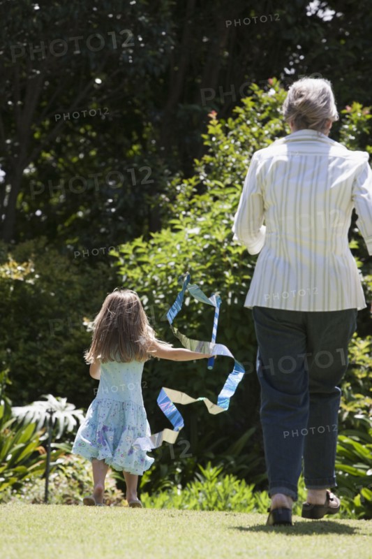 Senior Caucasian woman and granddaughter playing outdoors