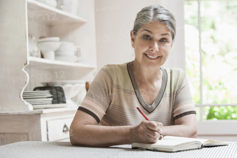 Caucasian woman writing in journal