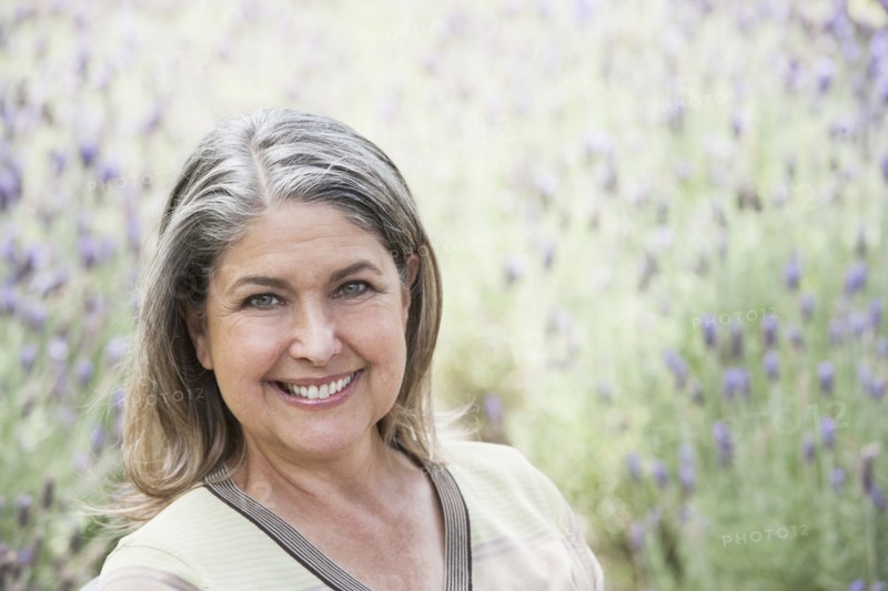 Caucasian woman smiling in lavender field