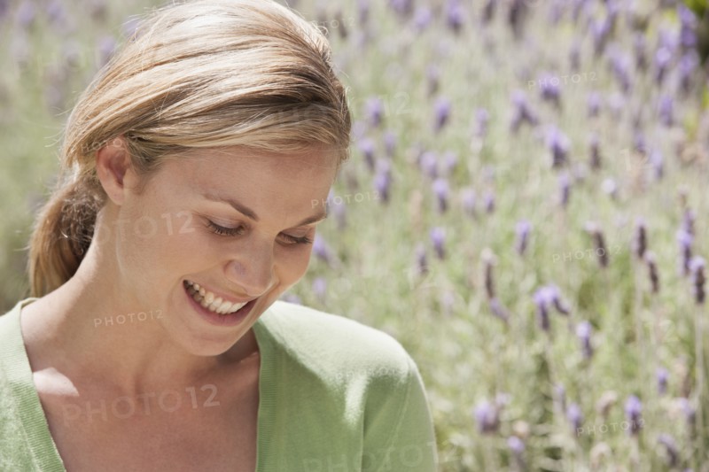 Caucasian woman smiling in lavender field