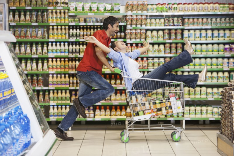 Caucasian couple playing in grocery store