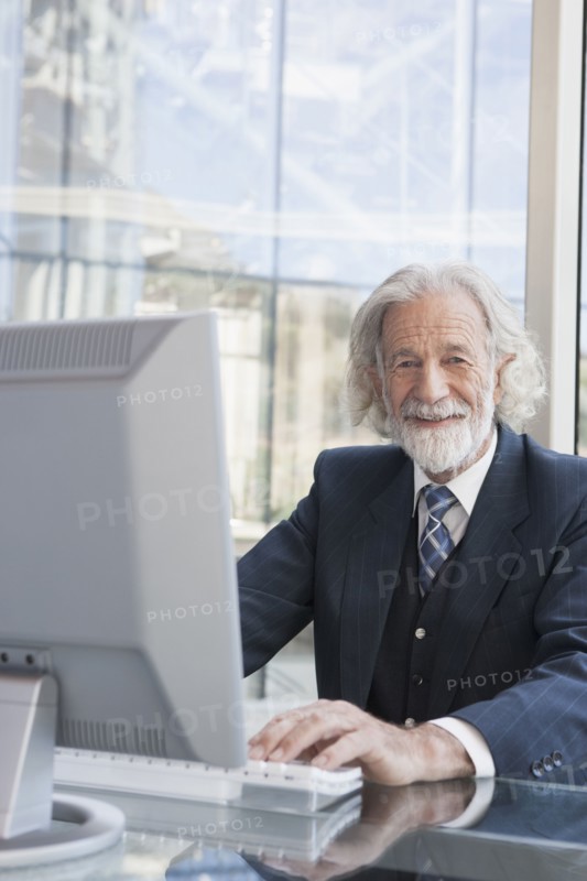 Senior Caucasian businessman working at desk