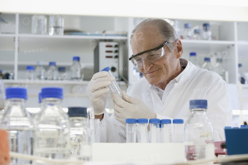 Senior Caucasian scientist examining samples in lab
