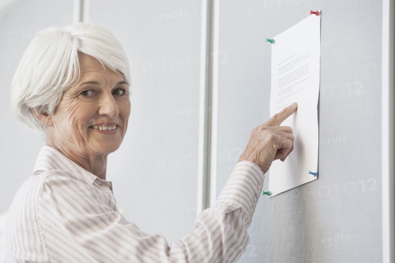Senior Caucasian woman reading sign