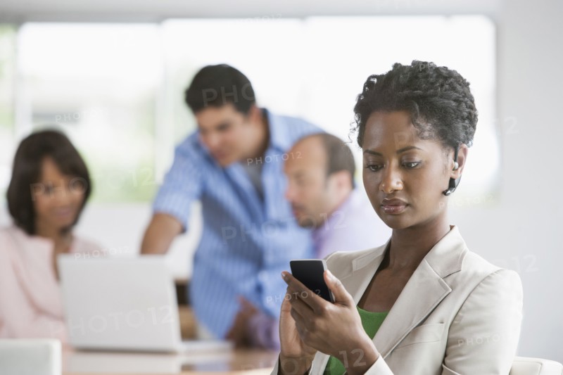 Businesswoman using cell phone in office